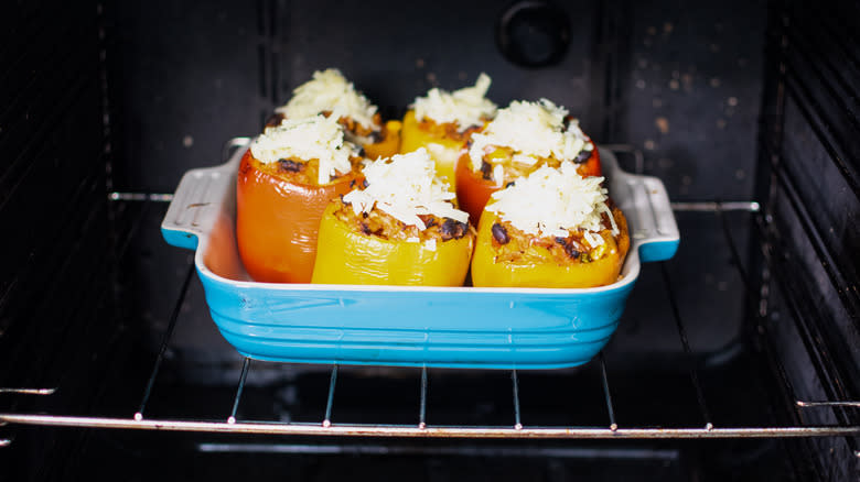 bell peppers stuffed with rice, beans and corn in baking dish