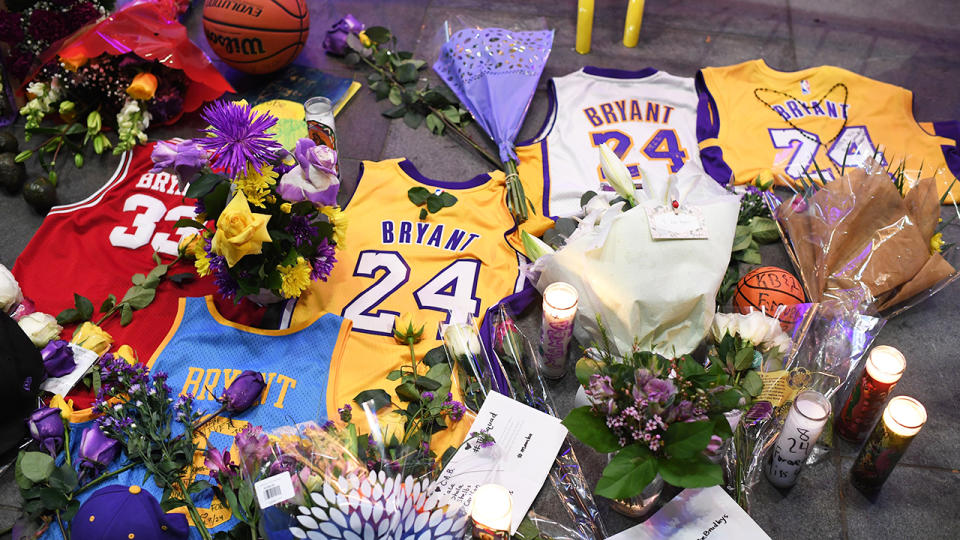 Jerseys, flowers and candles, pictured here at a makeshift memorial for Kobe Bryant in front of Staples Centre.