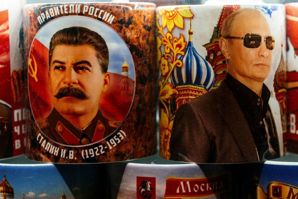 Mugs decorated with images of Russian President Vladimir Putin and Soviet leader Josef Stalin are seen on sale among other items at a gift shop in Moscow on March 11, 2020. <a href="https://www.gettyimages.com/detail/news-photo/mugs-decorated-with-images-of-russian-president-vladimir-news-photo/1206547055?adppopup=true" rel="nofollow noopener" target="_blank" data-ylk="slk:Dimitar Dilkoff/AFP via Getty Images;elm:context_link;itc:0;sec:content-canvas" class="link ">Dimitar Dilkoff/AFP via Getty Images</a>