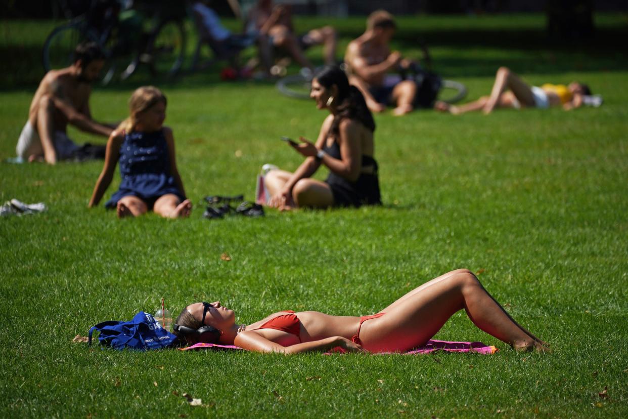 People enjoy the hot weather in St James's Park, London (PA)