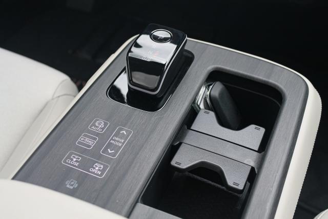 The gear selector of the 2023 Nissan Ariya Empower+, with faux-wood trim surrounding.
