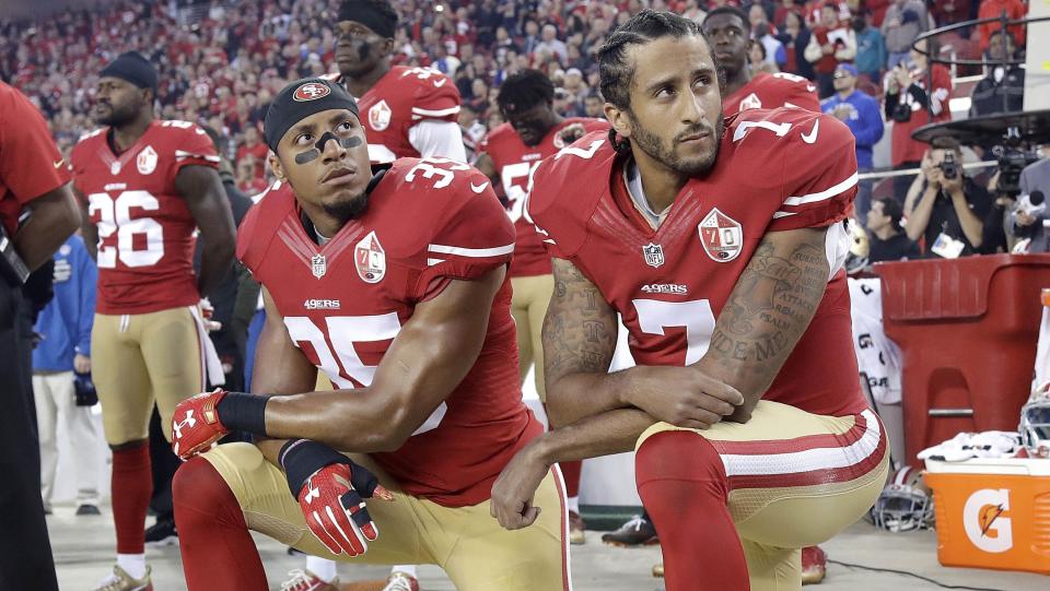 Eric Reid, left, and Colin Kaepernick kneel during the national anthem before an NFL game. (AP)