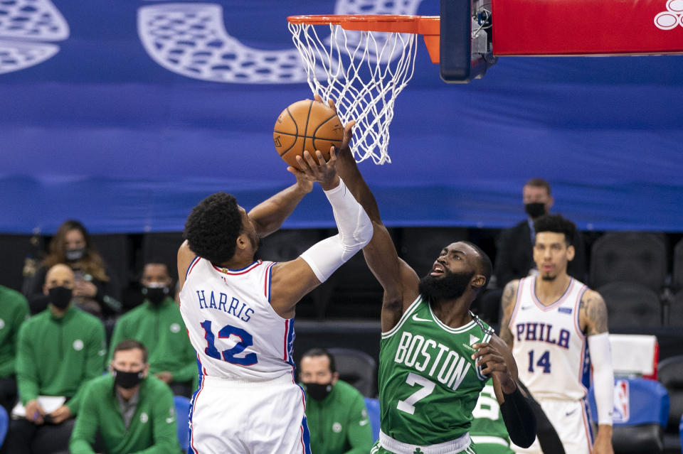 Boston Celtics guard Jaylen Brown, right, blocks a shot by Philadelphia 76ers forward Tobias Harris during the first half of an NBA basketball game Wednesday, Jan. 20, 2021, in Philadelphia. (AP Photo/Chris Szagola)