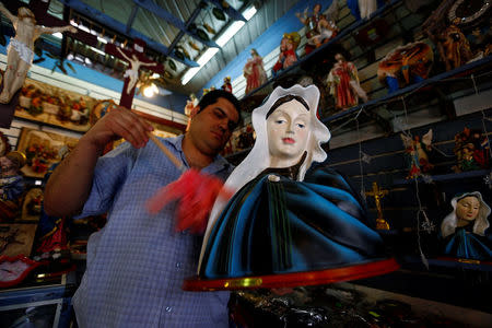 A man works inside a Christian souvenir shop ahead of Pope Francis’ visit in Cairo, Egypt April 27, 2017. REUTERS/Amr Abdallah Dalsh