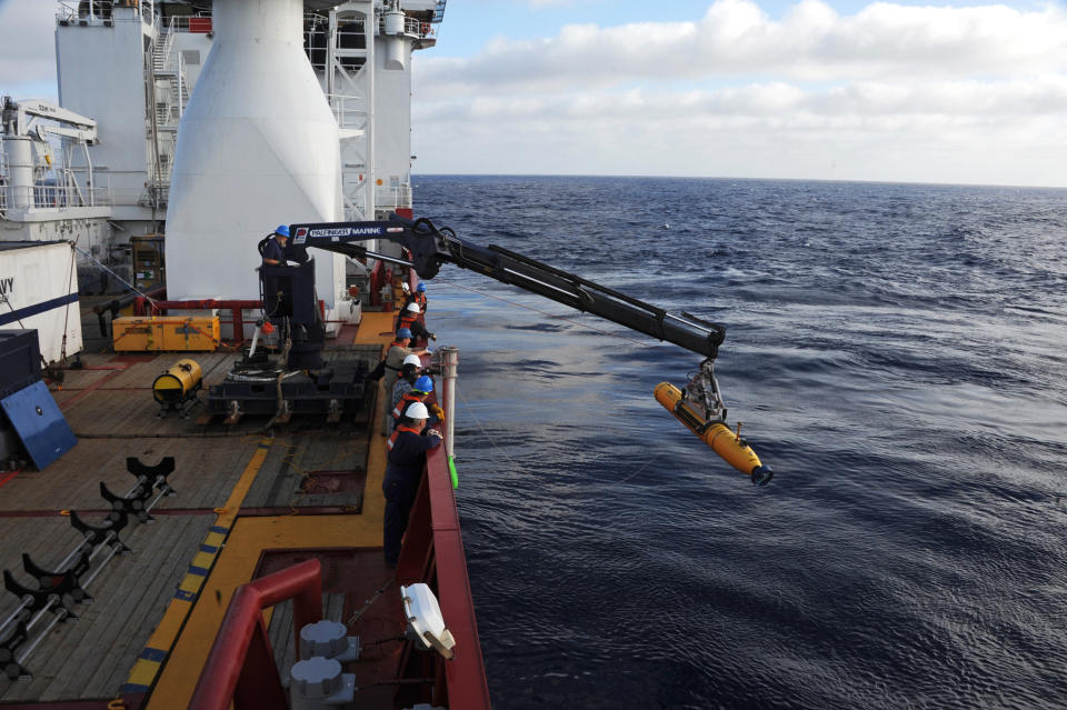 In a Monday, April 14, 2014 photo provided by the U.S. Navy, operators aboard the Australian defense vessel Ocean Shield move the U.S. Navy's Bluefin-21 autonomous underwater vehicle into position for deployment to search for the missing Malaysia Airlines Flight 370. On Tuesday, April 15, 2014, the U.S. Navy and search coordinators said that a built-in safety feature aborted what was supposed to have been a 16-hour mission to create a sonar map of the ocean floor after only six hours. (AP Photo/U.S. Navy, MC1 Peter D. Blair)