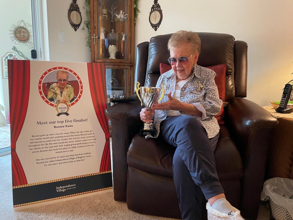 'Bootsie' Kawa shows off her first-place trophy from her home at Independence Village of Brighton Valley, which she won for her yodeling talent in the 2023 Ageless Talent Show among residents in StoryPoint Group senior living communities across the country, Tuesday, May 23, 2023.