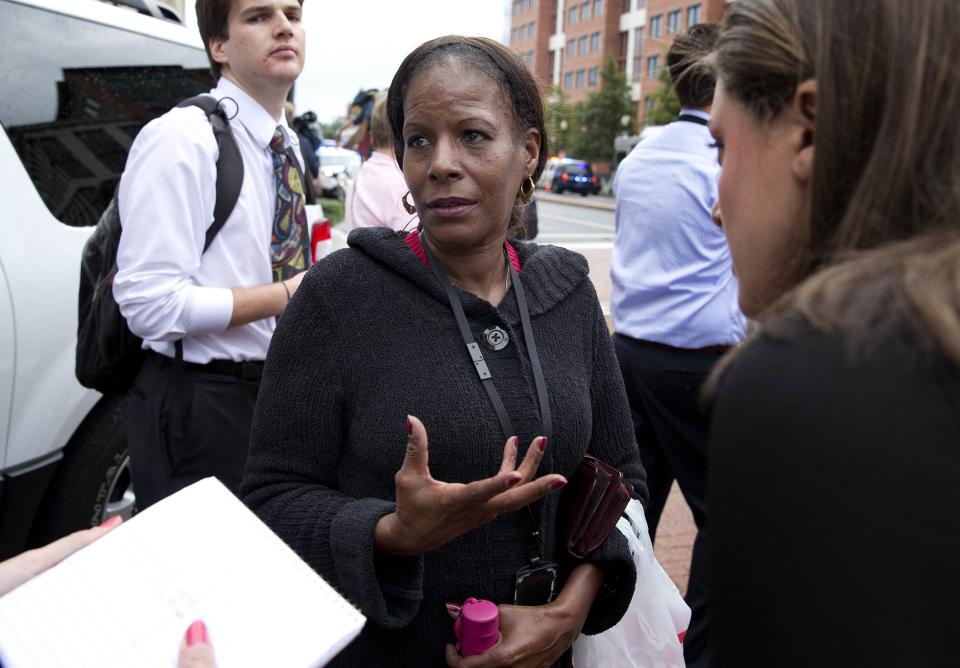 Patricia Ward, an employee at the Washington Navy Yard, speaks to the media about what she witnessed as police respond to a shooting at the Washington Navy Yard in Washington, September 16, 2013. (REUTERS/Joshua Roberts)