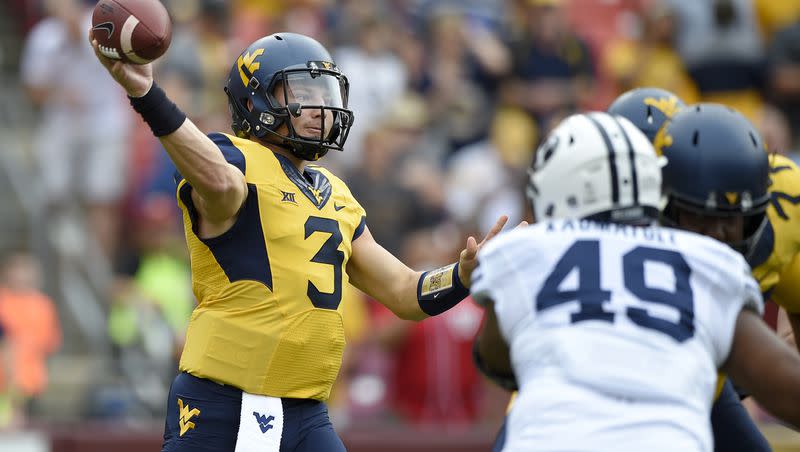 West Virginia quarterback Skyler Howard passes while pressured by BYU defensive lineman Moses Kaumatule Saturday, Sept. 24, 2016, in Landover, Md. The two teams meet again this Saturday, this time in Morgantown, West Virginia.