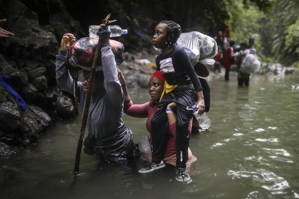 Haitian migrants wade through water as they cross the Darien Gap from Colombia to Panama in hopes of reaching the U.S., Tuesday, May 9, 2023. The image was part of a series by Associated Press photographers Ivan Valencia, Eduardo Verdugo, Felix Marquez, Marco Ugarte Fernando Llano, Eric Gay, Gregory Bull and Christian Chavez that won the 2024 Pulitzer Prize for feature photography. (AP Photo/Ivan Valencia)