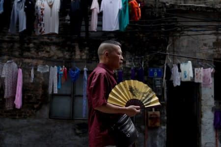 The Wider Image: China's Guangzhou rides economic change but keeps traditions