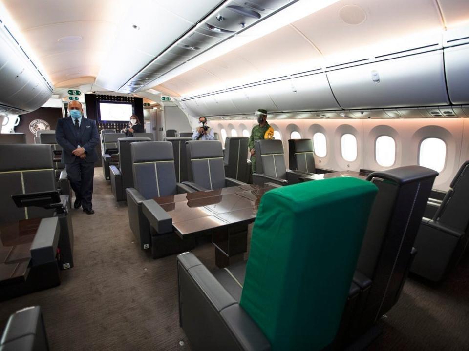 Mexico's presidential jet with green and grey chairs in a quad-style arrangement around tables.