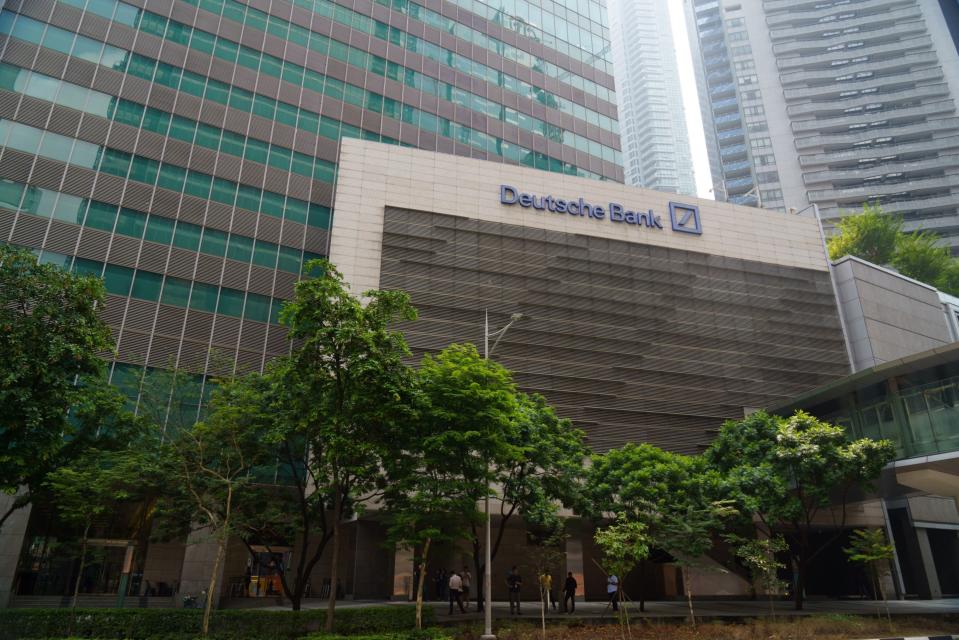 Deutsche Bank AG signage at the One Raffles Quay complex in Singapore, on Friday, April 14, 2023. Photographer: Ore Huiying/Bloomberg