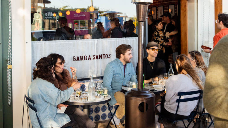 Guests sitting on the Barra Santos patio
