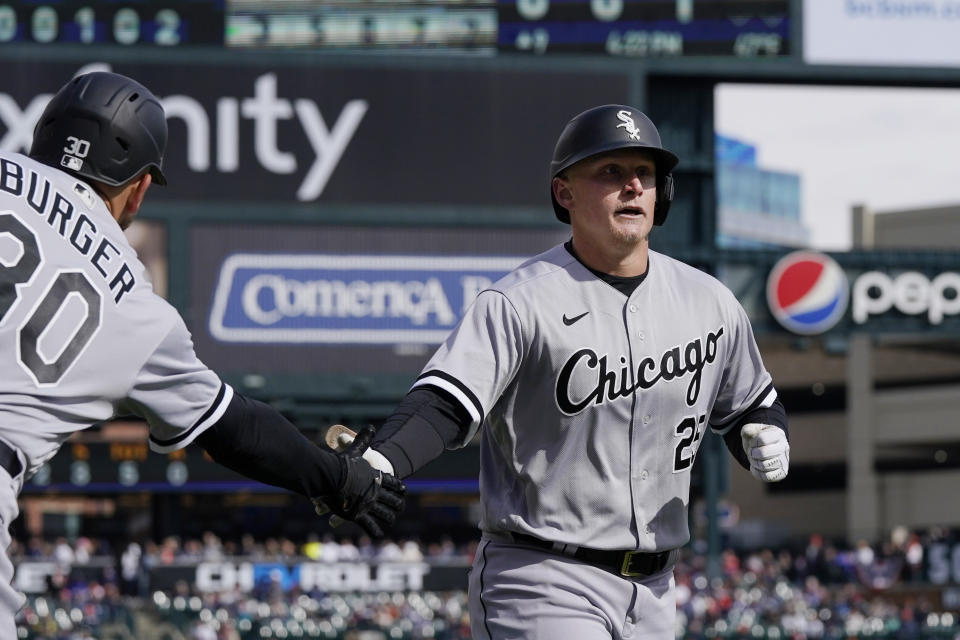 Chicago White Sox designated hitter Andrew Vaughn is greeted by Jake Burger after hitting a solo home run during the ninth inning of a baseball game against the Detroit Tigers, Friday, April 8, 2022, in Detroit. (AP Photo/Carlos Osorio)