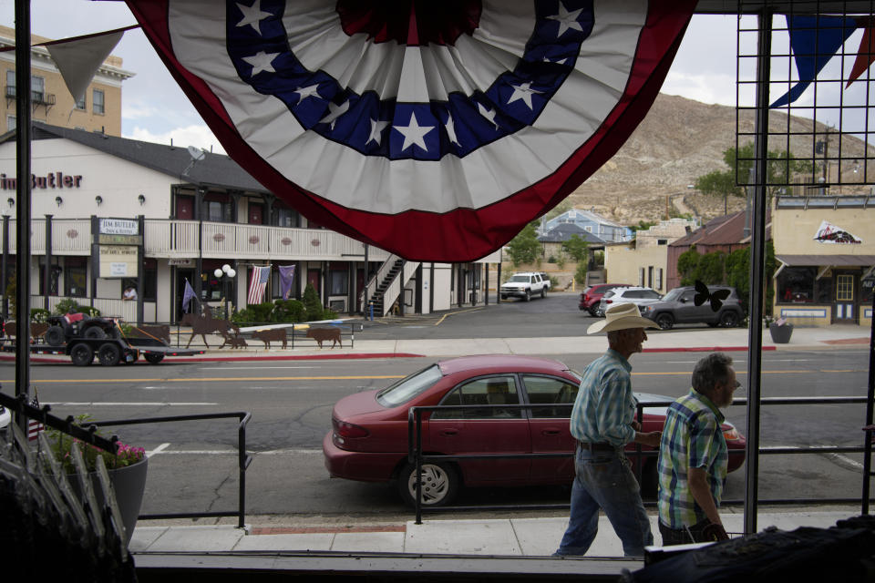 FILE - People walk along the main drag in the county seat of Nye County on July 18, 2022, in Tonopah, Nev. Nevada voters will consider a ballot question on Nov. 8, 2022, that would enshrine in the state constitution a ban on discrimination based on race, color, creed, sex, sexual orientation, gender identity or express, age, disability, ancestry or national origin. Nevadans will also weigh in on ranked-choice voting and the state's minimum wage. (AP Photo/John Locher, File)