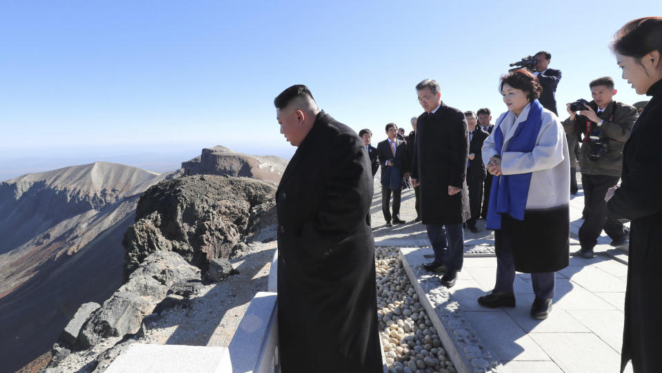 South Korean President Moon Jae-in, second from left, and his wife Kim Jung-sook, second from right, North Korean leader Kim Jong Un, left, and his wife Ri Sol Ju, right, visit Mount Paektu in North Korea, Thursday, Sept. 20, 2018. (Pyongyang Press Corps Pool via AP)