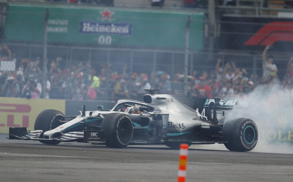 Mercedes driver Lewis Hamilton, of Britain, burns rubber as he celebrates his victory in the Formula One Mexico Grand Prix auto race at the Hermanos Rodriguez racetrack in Mexico City, Sunday, Oct. 27, 2019. (AP Photo/Eduardo Verdugo)