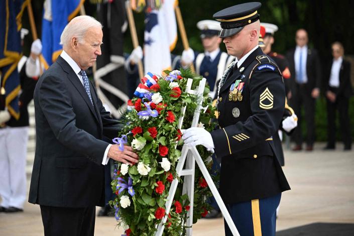 President Joe Biden participates in a wreath laying ceremony at the Tomb of the Unknown Soldier at Arlington National Cemetery.