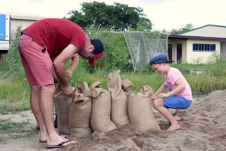 Residents fill sandbags in preparation for the arrival of Cyclone Debbie in the northern Australian town of Bowen, located south of Townsville. AAP/Sarah Motherwell/via REUTERS