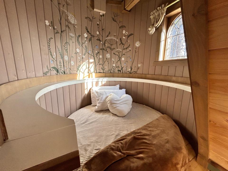 top floor of Rapunzel's Cottage with floral walls and circle bed