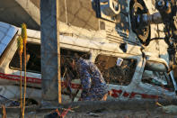 <p>A soldier observes the remains of the military helicopter that fell on a van in Santiago Jamiltepec, Oaxaca state, Mexico, on Feb.17, 2018. (Photo: Patricia Castellanos/AFP/Getty Images) </p>