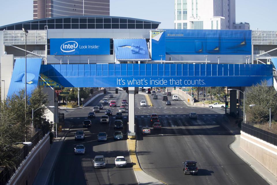 Traffic passes under monorail station covered by an advertisement from Intel for the 2014 Consumer Electronics Show (CES) near the Las Vegas Convention Center in Las Vegas