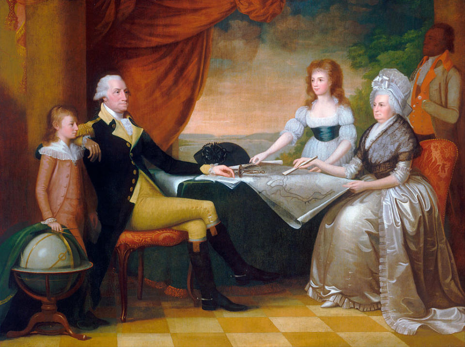 The Washington Family by Edward Savage (American, 1761 - 1817); oil on canvas, 1789 - 96, from the National Gallery, Washington, DC. The Washington family sits in a room overlooking the Potomac River in Washington, studying an architectural plan for the future grand construction of the capitol city. | GraphicaArtis/Getty Images