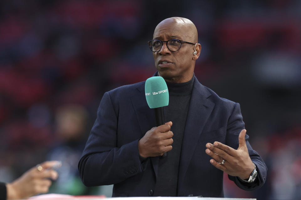 FILE- TV pundit and former soccer player Ian Wright speaks on the sideline before the Women's Finalissima soccer match between England and Brazil at Wembley stadium in London, Thursday, April 6, 2023. Former Arsenal soccer player turned pundit Ian Wright was handed the Order of the British Empire in King Charles III's first birthday honors list, which were unveiled late Friday, June 16, 2023. (AP Photo/Ian Walton, file)