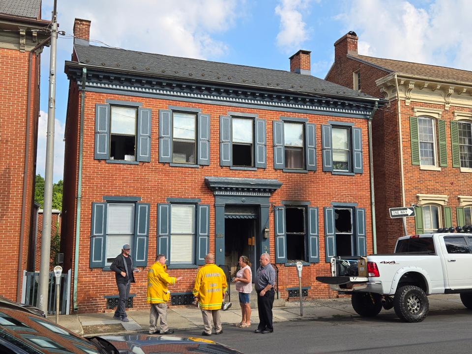 Code enforcement and fire department officials work at the scene of an apartment fire caused by the lithium battery of an electric bike on the 100 block of Broadway on Monday morning, June 17, 2024, in Hanover Borough.