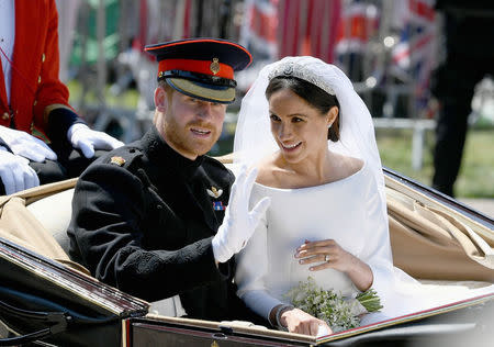 Prince Harry, Duke of Sussex and Meghan, Duchess of Sussex leave Windsor Castle in the Ascot Landau carriage during a procession after getting married at St Georges Chapel Windsor, Britain May 19, 2018. Jeff J Mitchell/Pool via REUTERS