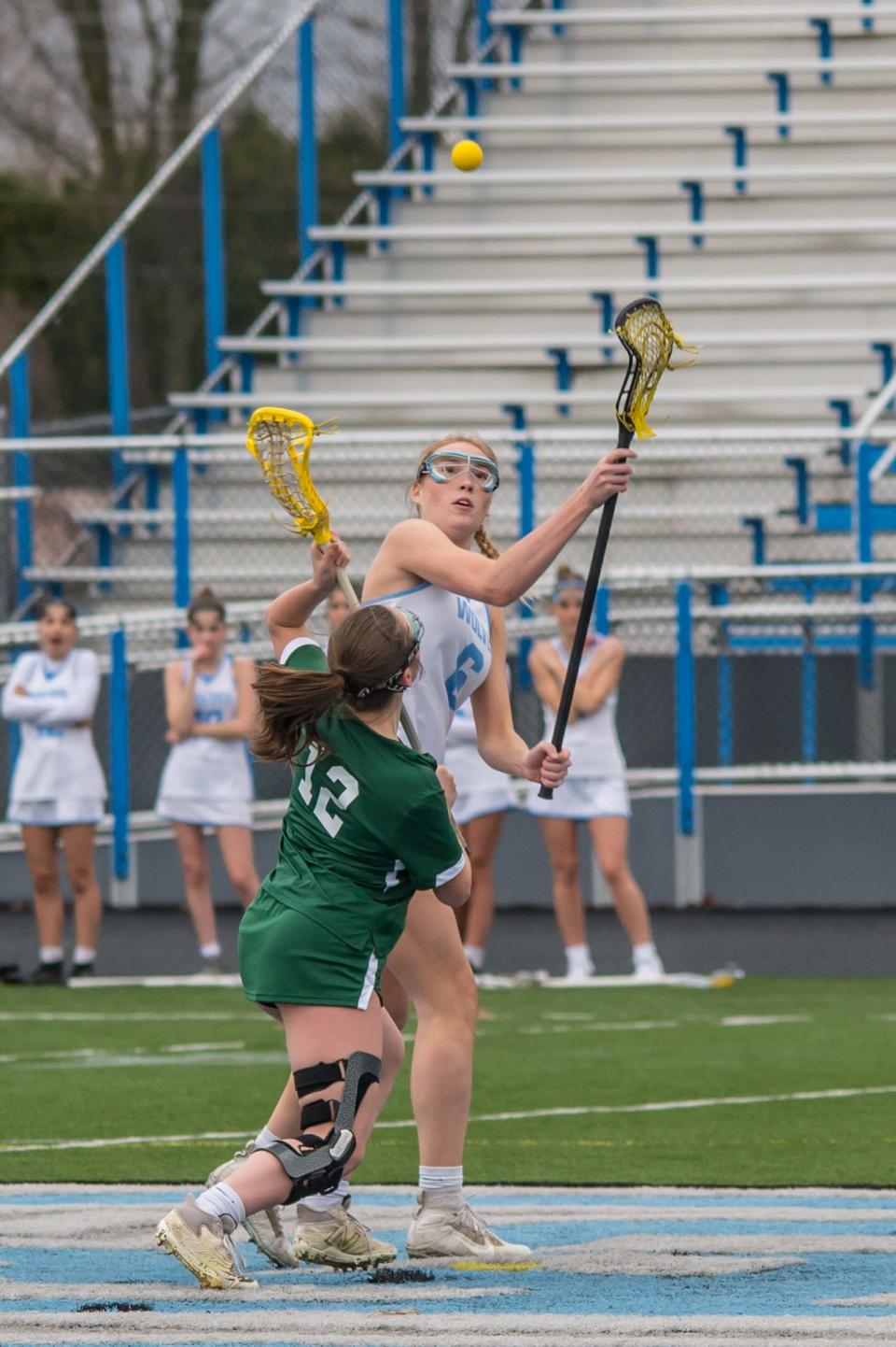 Rice's Gillian Grimes and South Burlington's Rachel Kelley battle for the draw during the Green Knights' 13-5 loss to the Wolves on Thursday afternoon in South Burlington.