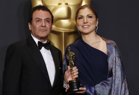 89th Academy Awards - Oscars Backstage - Hollywood, California, U.S. - 26/02/17 - Anousheh Ansari and Firouz Naderi pose with the Oscar they accepted on behalf of Asghar Farhadi, who won the Best Foreign Language Film for "The Salesman". REUTERS/Lucas Jackson