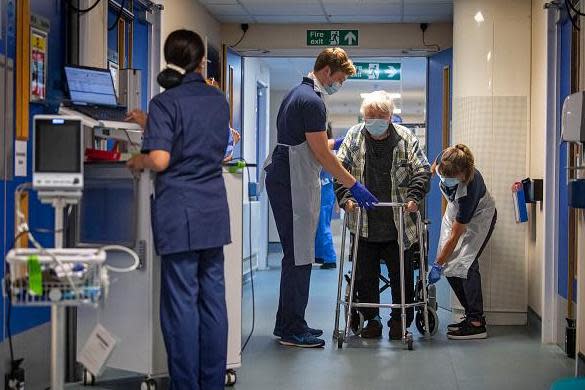 Hospital staff with a patient (POOL/AFP via Getty Images)