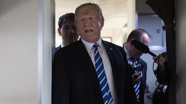 PHOTO: President Donald Trump speaks to reporters on board Air Force One as he travels back to Washington, Apr. 5, 2018. (Nicholas Kamm/AFP via Getty Images)