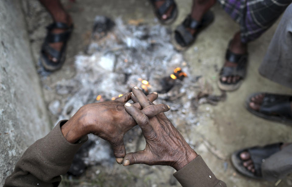 A Bangladeshi man warms himself with others near a bonfire early morning in Narayanganj, near Dhaka, Bangladesh, Monday, Jan. 6, 2014. Bangladesh's ruling Awami League won one of the most violent elections in the country's history, marred by street fighting, low turnout and a boycott by the opposition that made the results a foregone conclusion. (AP Photo/A.M. Ahad)