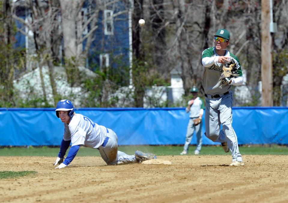 Duxbury shortstop Ryan Flaherty, right, throws to first in a double play attempt after forcing out Braintree's Nick Rucky, left, during high school baseball action at Braintree High School, Monday, April 18, 2022.
