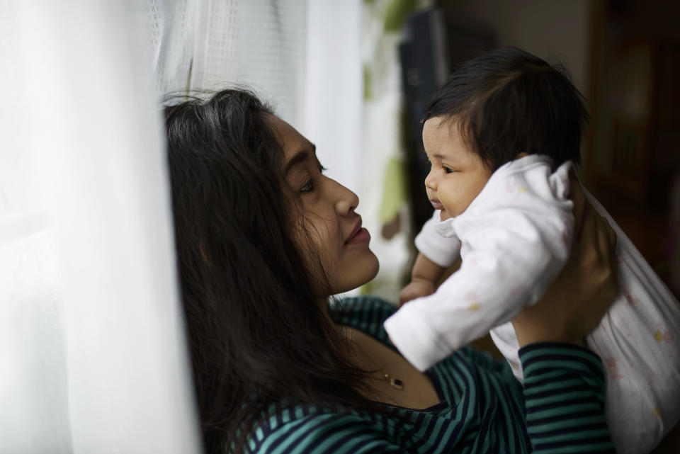 A mother holding her baby