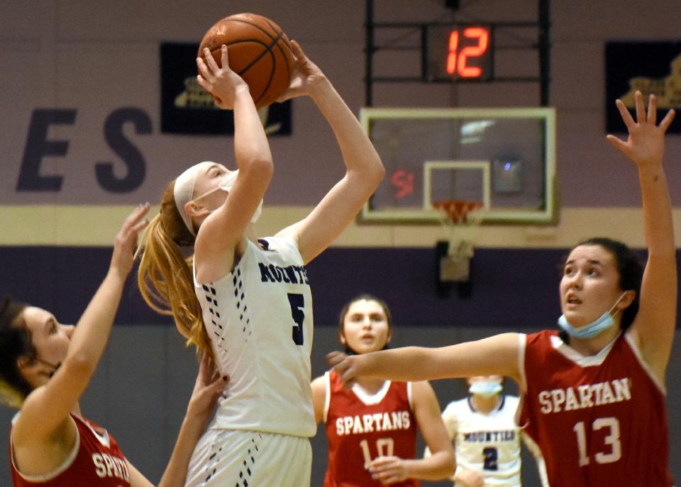 Little Falls Mountie Shayna Straney (5) drives the baseline for her tie-breaking basket in the final minute of Monday's game against New Hartford.