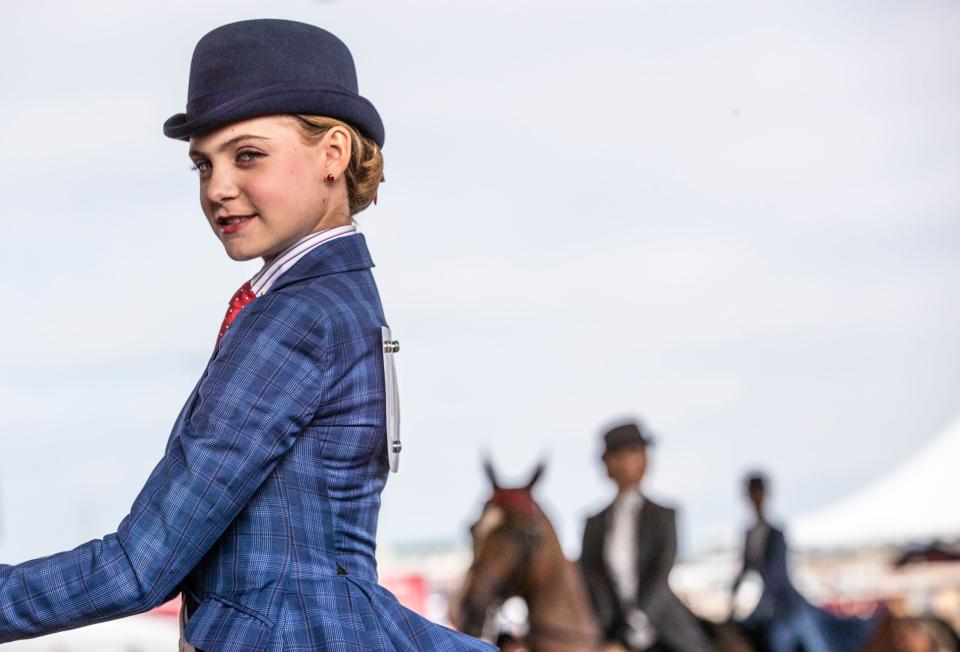 A young equestrian looks confident on her mount before entering the ring in a juniors competition at the World Championship Horse Show at Louisville's Expo Center. Aug. 22, 2022