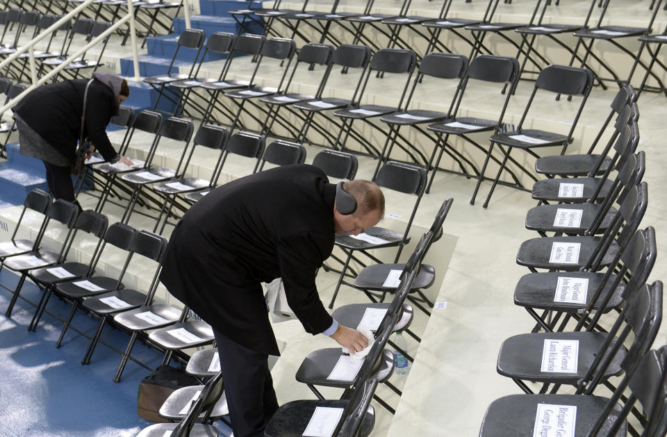 <p>Workers dry the seats on the stage at the U.S. Capitol on Inauguration Day on January 20, 2017 in Washington, DC. (Photo: Saul Loeb – Pool/Getty Images) </p>