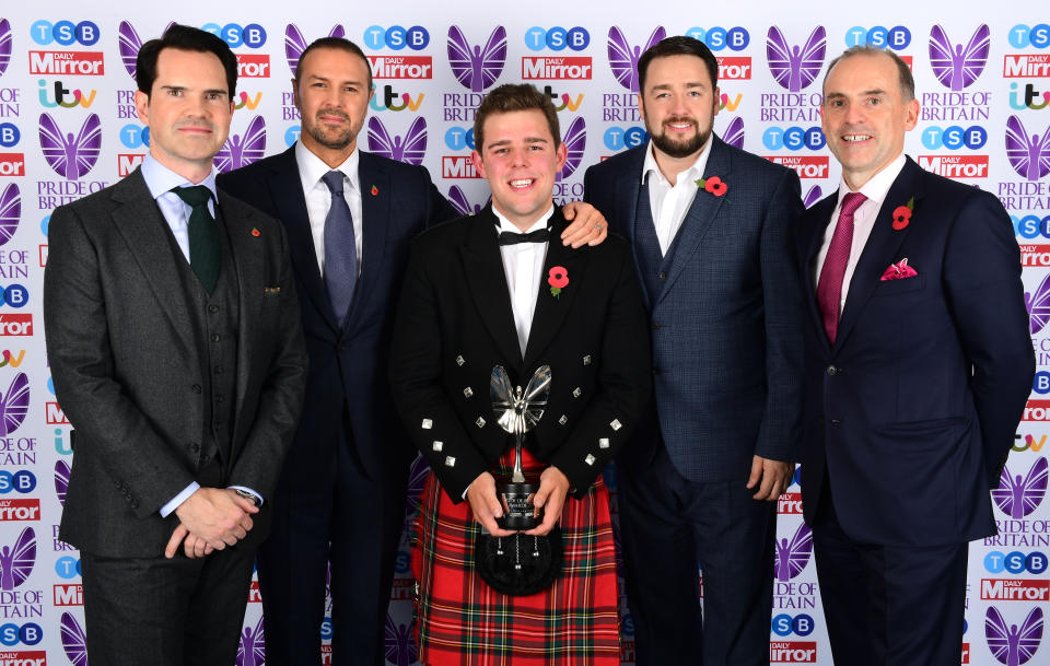 Fraser Johnston (centre) is presented the TSB Community Partner award by Jimmy Carr (left), Paddy McGuinness and Jason Manford (2nd from right) during The Pride of Britain Awards 2017, at Grosvenor House, Park Street, London. Picture Date: Monday 30 October. Photo credit should read: Ian West/PA Wire