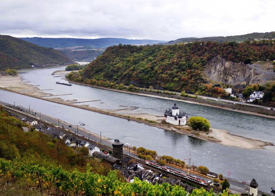 In this Wednesday, Oct.24, 2018 picture the Pfalzgrafenstein castle from the 14th century sits on a sandbank in the river Rhine in Kaub, Germany, during historically low water levels. A hot, dry summer has left German waterways at record low levels, causing chaos for the inland shipping industry, environmental damage and billions of euros of losses _ a scenario that experts warn could portend things to come as global temperatures rise. (AP Photo/Michael Probst)