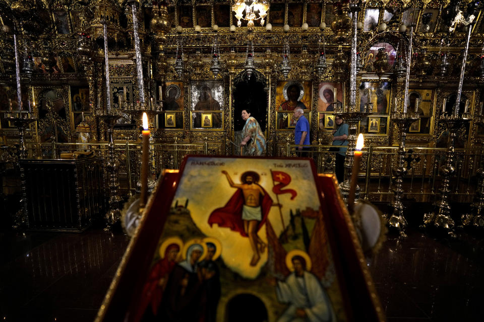 Tourists visit the Kykkos monastery on Troodos mountains, in the island of Cyprus, Friday, May 27, 2022. Hundreds of Russian and Ukrainian Orthodox faithful visiting Cyprus would stream daily past the icon of the Virgin Mary at Kykkos Monastery to venerate the relic that tradition dictates was fashioned by Luke the Evangelist and blessed by the Virgin herself. But a European Union ban on flights to and from Russia as a result of Russia's invasion of Ukraine has meant a loss of 800,000 vacationers - a fifth of all tourists to Cyprus in record-setting 2019. (AP Photo/Petros Karadjias)