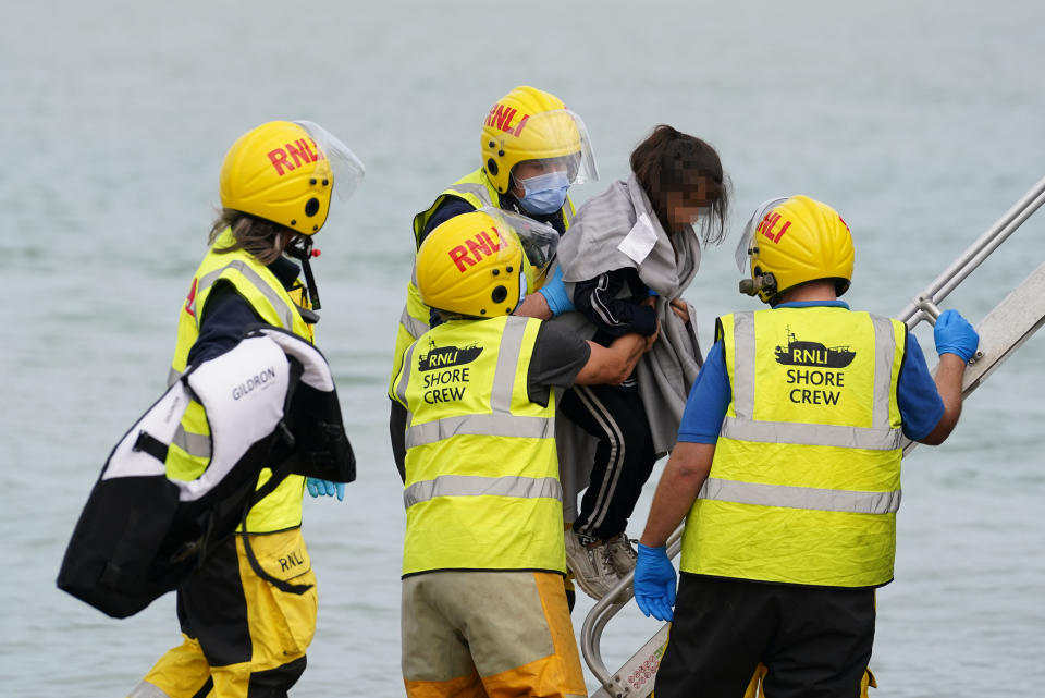 EDITORS NOTE Children's faces have been pixelated as the PA Picture Desk has been unable to gain the necessary permission to photograph a child under 16 on issues involving their welfare. A child thought to be a migrant on Dungeness beach after being brought in by the Dungeness lifeboat following a small boat incident in the Channel. Picture date: Wednesday October 12, 2022.