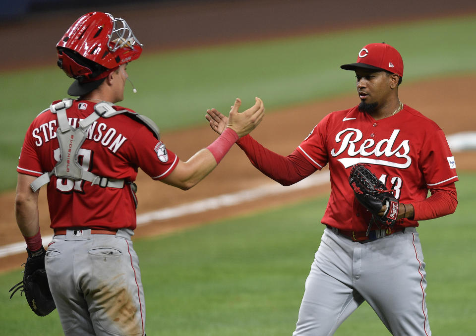 Cincinnati Reds relief pitcher Alexis Diaz, right, celebrates with catcher Tyler Stephenson after the team's win over the Miami Marlins in a baseball game Friday, May 12, 2023, in Miami. (AP Photo/Michael Laughlin)