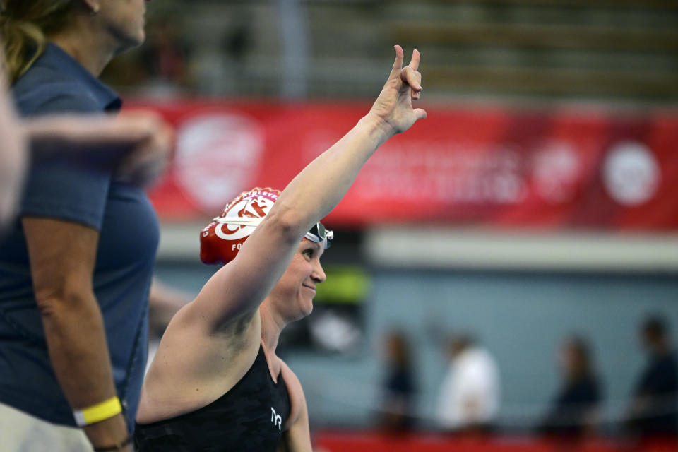 Christie Raleigh Crossley raises her hand before swimming the Women's 100 freestyle at the 2024 U.S. Paralympic Swim Team Trials in Minneapolis, Friday, June 28, 2024. (AP Photo/Leighton Smithwick)
