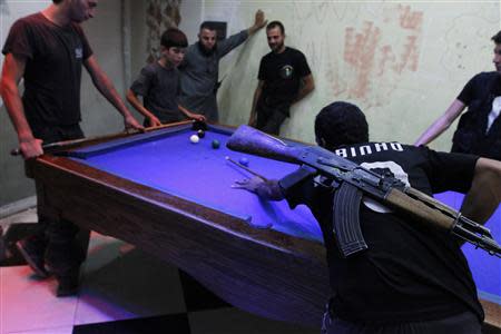 Free Syrian Army fighters play pool as they rest in the old city of Aleppo September 9, 2013. REUTERS/Hamid Khatib