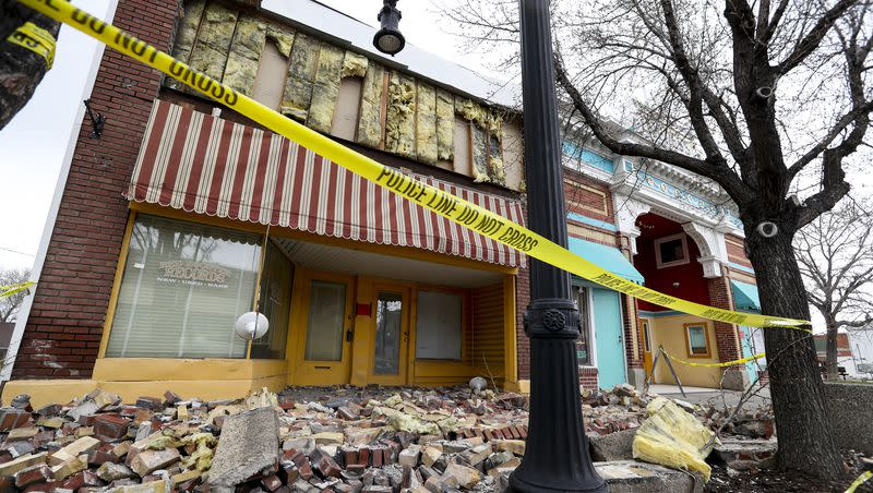 Caution tape surrounds a damaged building on Magna’s Main Street on Tuesday, March 24, 2020, following a 5.7 magnitude earthquake that was centered near the city on March 18. 