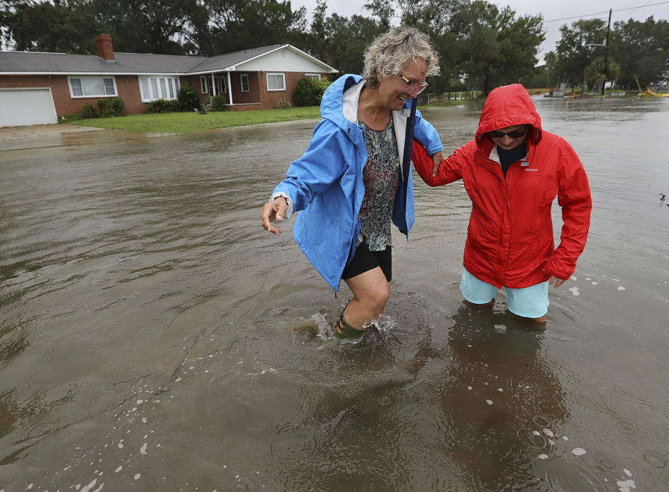 St. Mary's: Anne Herring (right) helps support her friend Jen Fabrick (left) as they walk through flood waters near their homes on St. Mary's Street while Hurricane Dorian passes by on Wednesday, Sept. 4, 2019, at St. Mary's. (Photo: Curtis Compton/Atlanta Journal-Constitution via AP)