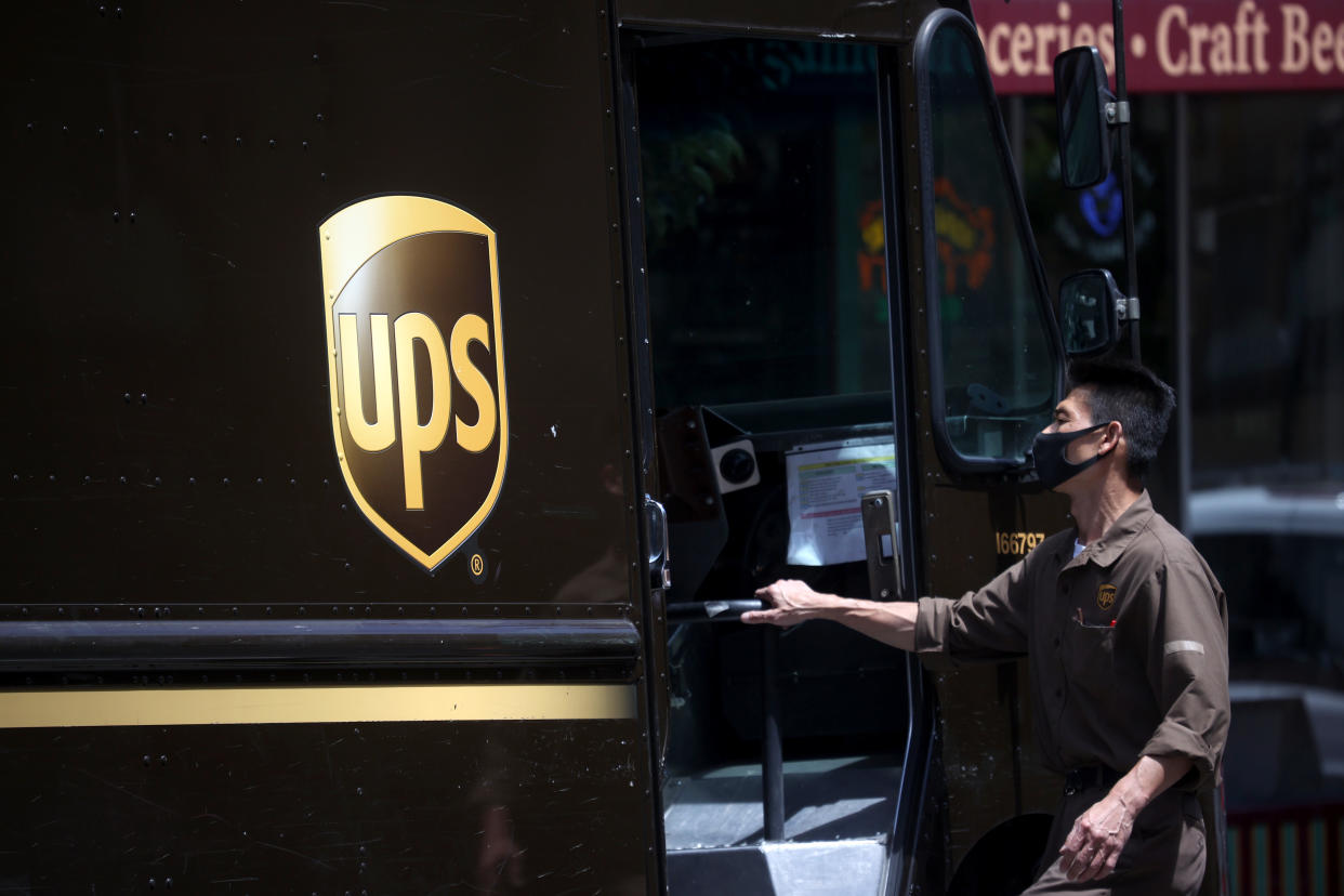 SAN FRANCISCO, CALIFORNIA - JULY 30: A United Parcel Service (UPS) driver gets into his truck while on his delivery route on July 30, 2020 in San Francisco, California. UPS reported a 13.4 percent surge in quarterly revenues to $20.46 billion beating analysts estimates of $17.48 billion. The global shipping company's net income rose 4.7% to $1.77 billion for the quarter.  (Photo by Justin Sullivan/Getty Images)